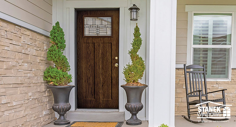 Dark wood front entry door Dark wood front entry door in Shaker style with Art Deco patterned in glass inset.